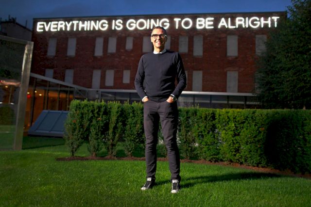 Bob Rennie on the roof of the Wing Sang building. In the background: Martin Creed, Work No. 851: EVERYTHING IS GOING TO BE ALRIGHT, 2008 AND Dan Graham. Two Half Cylinders, 2008/ Courtesy Rennie Collection