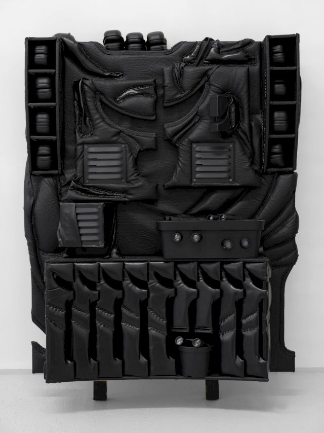 Cezary Poniatowski, untitled, leatherette, plywood, upholstery foam, earmuffs, staples, binoculars, 125 x 100 x 20 cm, 2023. Photo courtesy of the artist and Havrlant Art Collection