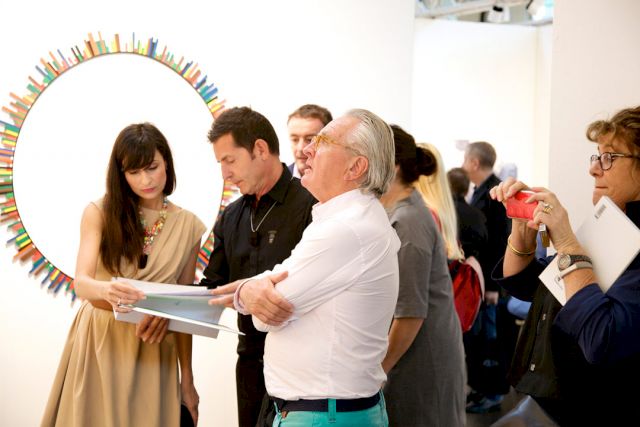 Johanna Capillure (left, of Rosa Santos Galería, Valencia) presents recent works by Andrea Canepa to collectors.